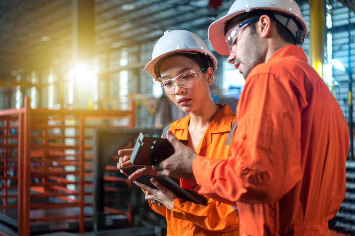 Industrial workers discuss and interact with mobi